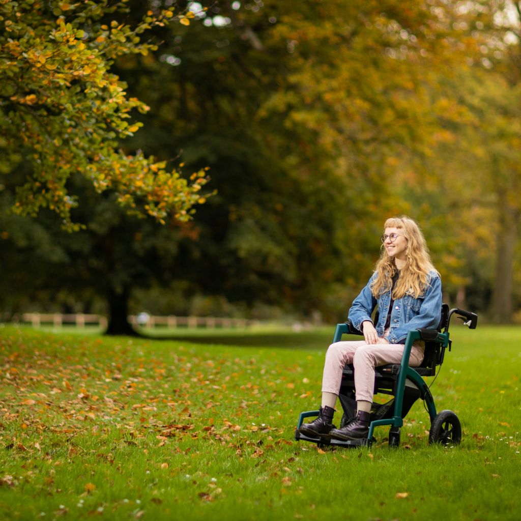 Lade in a wheelchair out in a park