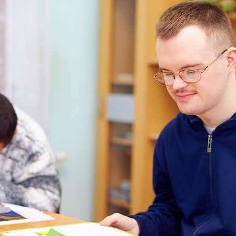 man with a disablity reading